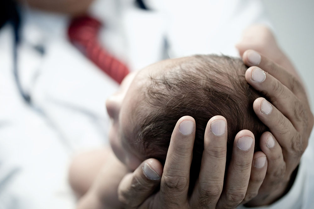 dr-holding-newborn-baby